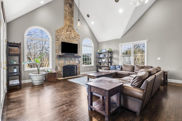 living room featuring a fireplace, recessed lighting, dark wood-type flooring, high vaulted ceiling, and baseboards