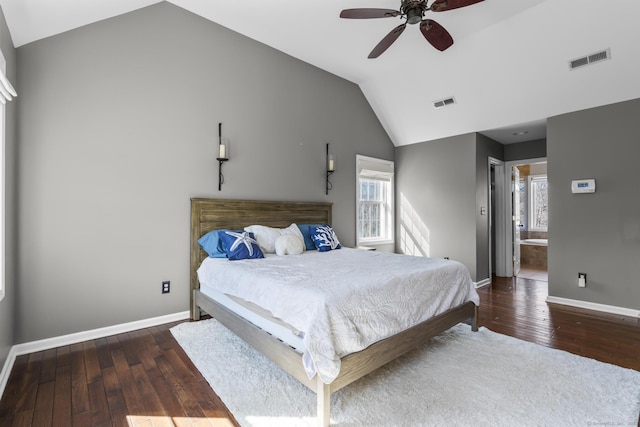 bedroom featuring lofted ceiling, visible vents, baseboards, and hardwood / wood-style flooring