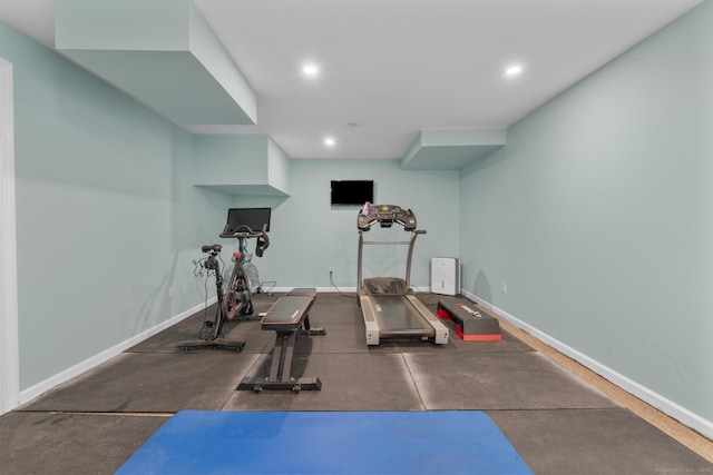 exercise room with recessed lighting and baseboards