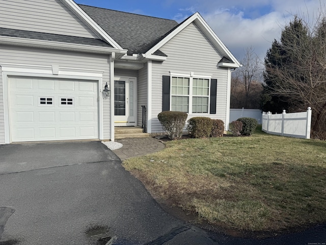 view of front facade featuring a front yard and a garage