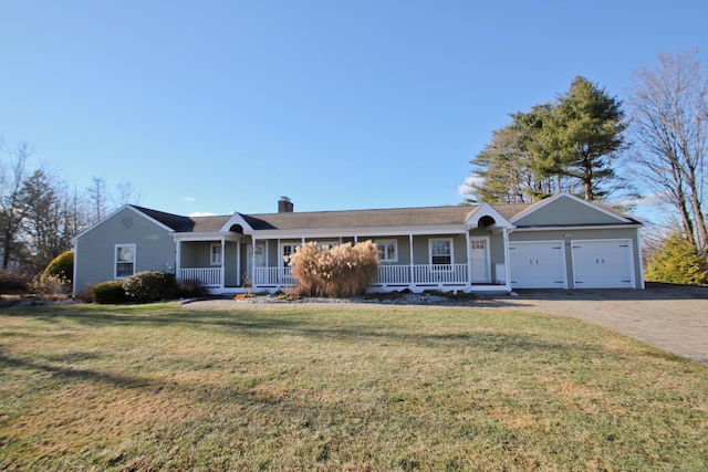 ranch-style house featuring covered porch, a front yard, and a garage