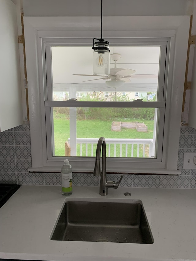 31 Gary Dr, Enfield, CT 06082 - kitchen view of a sink, tasteful backsplash, light countertops, and ceiling fan