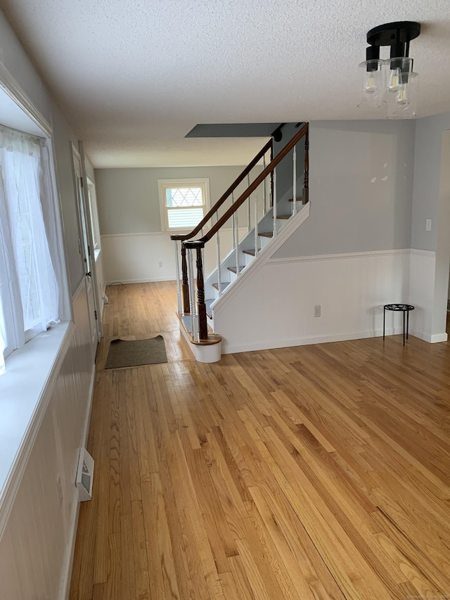 31 Gary Dr, Enfield, CT 06082 - entryway with light wood-type flooring, stairway, and a textured ceiling