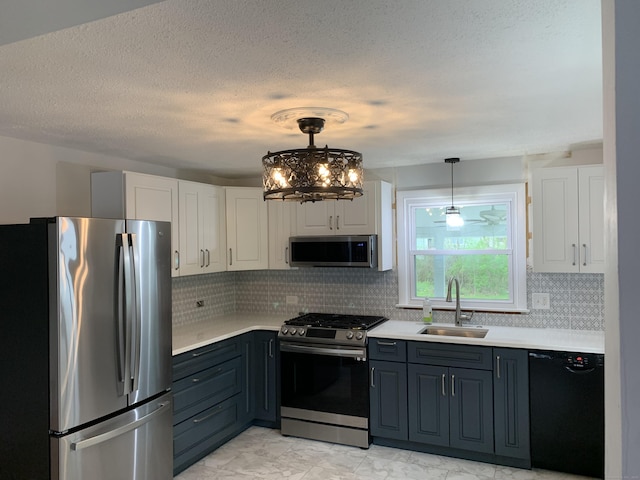31 Gary Dr, Enfield, CT 06082 - kitchen with stainless steel appliances, a sink, white cabinetry, light countertops, and a textured ceiling