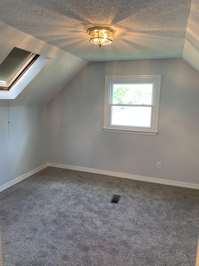31 Gary Dr, Enfield, CT 06082 - bonus room featuring lofted ceiling, carpet, a textured ceiling, baseboards, and a skylight