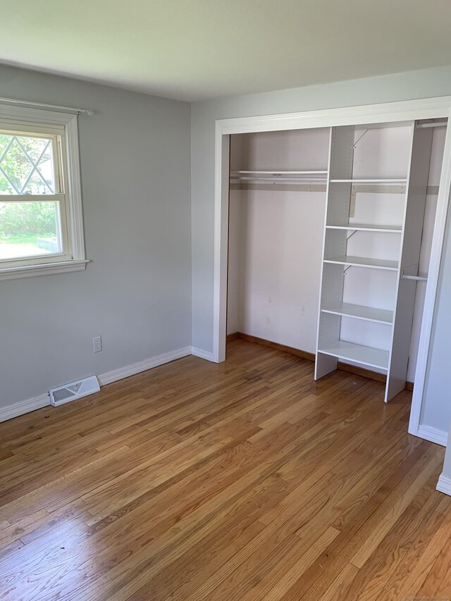 31 Gary Dr, Enfield, CT 06082 - unfurnished bedroom with light wood-type flooring, baseboards, and a closet