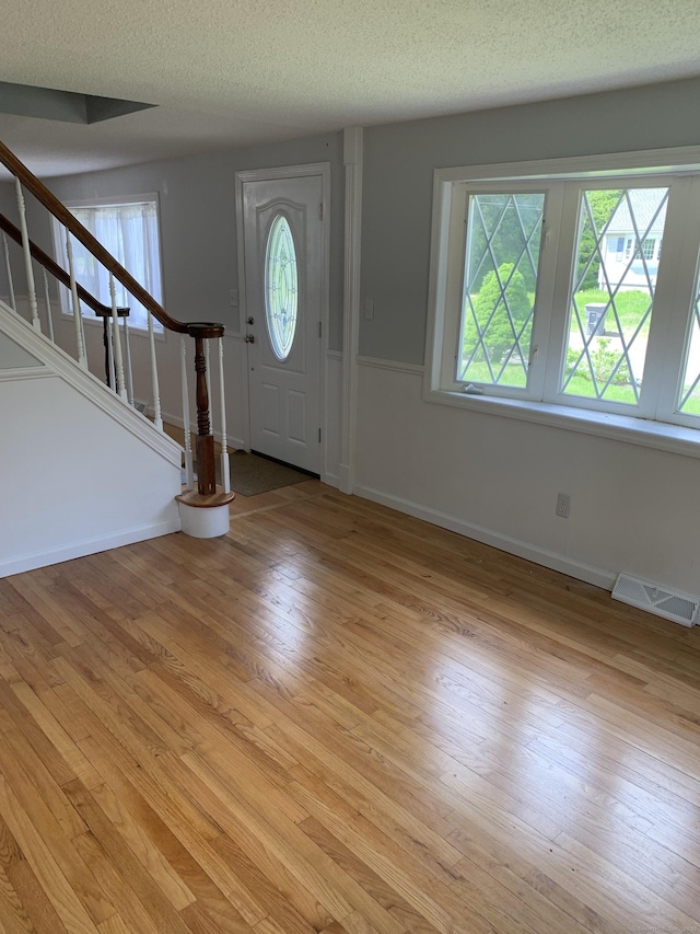 31 Gary Dr, Enfield, CT 06082 - foyer featuring stairway, light wood-style flooring, a textured ceiling, and baseboards