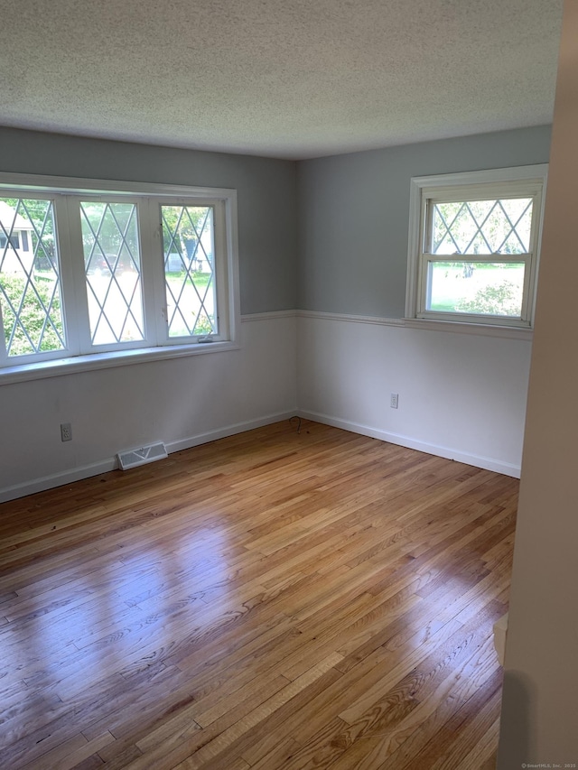 31 Gary Dr, Enfield, CT 06082 - unfurnished room with plenty of natural light, wood finished floors, a textured ceiling, and baseboards