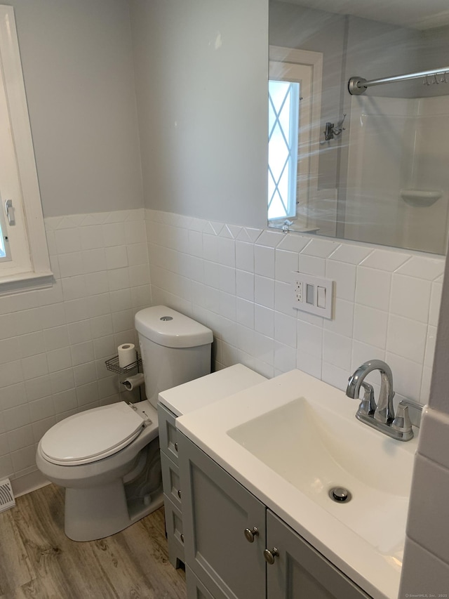 31 Gary Dr, Enfield, CT 06082 - bathroom with tile walls, wood finished floors, a shower, toilet, and vanity