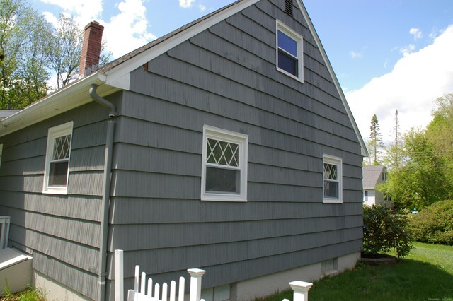 31 Gary Dr, Enfield, CT 06082 - view of side of property featuring a chimney and a lawn