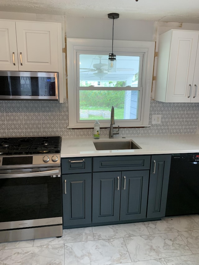 31 Gary Dr, Enfield, CT 06082 - kitchen featuring stainless steel appliances, a sink, light marble finish floors, white cabinetry, and light countertops