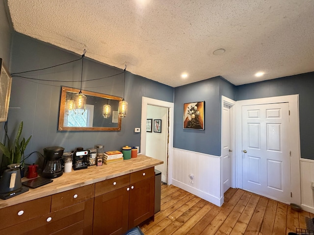 bathroom featuring a textured ceiling and hardwood / wood-style flooring