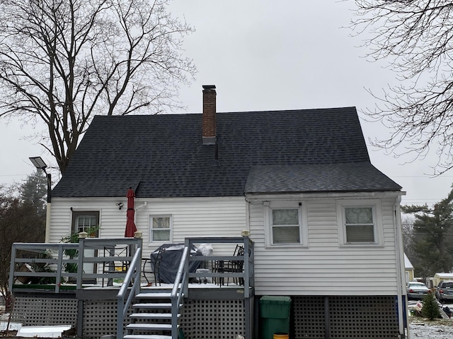 rear view of house featuring a wooden deck