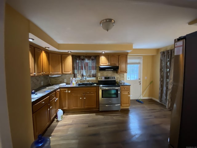 kitchen with backsplash, sink, stainless steel appliances, and dark hardwood / wood-style floors