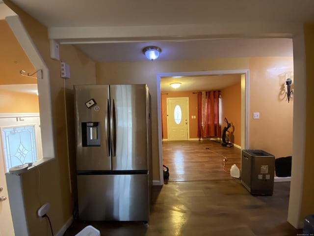 kitchen featuring stainless steel fridge and dark wood-type flooring