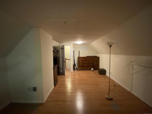 bonus room with light hardwood / wood-style flooring and lofted ceiling