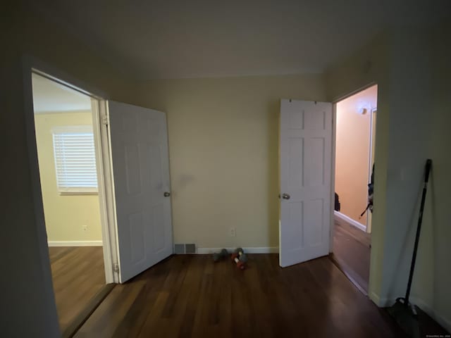 bedroom with dark hardwood / wood-style flooring