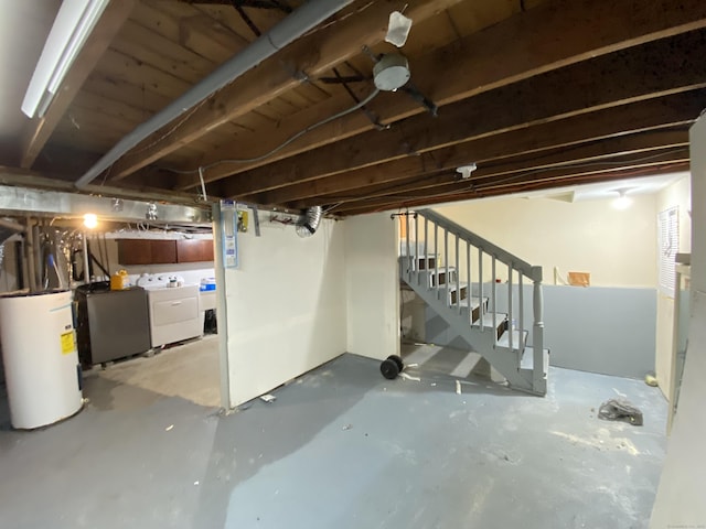 basement featuring washing machine and clothes dryer and water heater