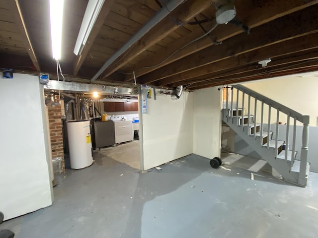 basement featuring washer and clothes dryer and gas water heater