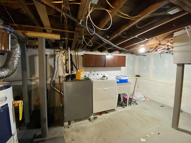 basement featuring washing machine and dryer and gas water heater