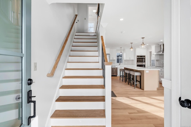 stairs with hardwood / wood-style flooring