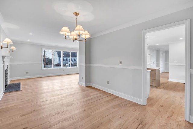 interior space featuring a chandelier, light hardwood / wood-style floors, and crown molding