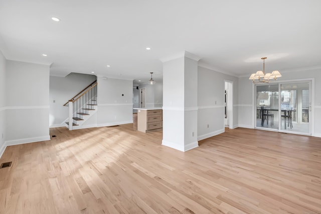 unfurnished living room featuring light wood-type flooring, ornamental molding, and a chandelier