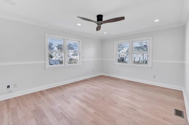 spare room featuring plenty of natural light, ceiling fan, crown molding, and light hardwood / wood-style flooring