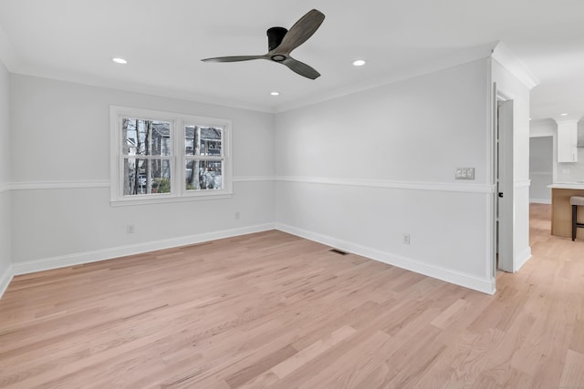 spare room with ceiling fan, crown molding, and light hardwood / wood-style flooring