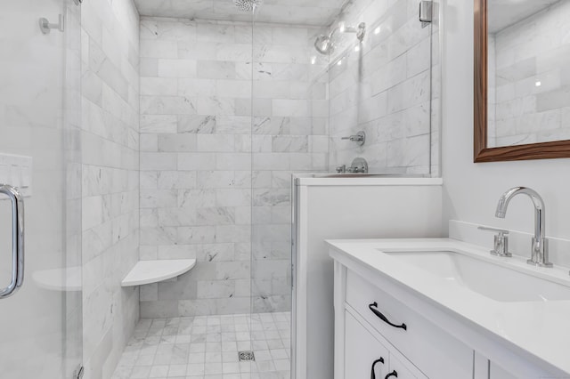 bathroom with a shower with door and vanity