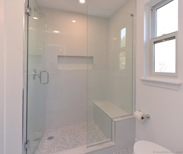 bathroom with toilet and walk in shower