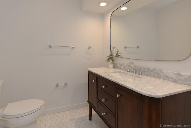 bathroom featuring tile patterned flooring, vanity, and toilet