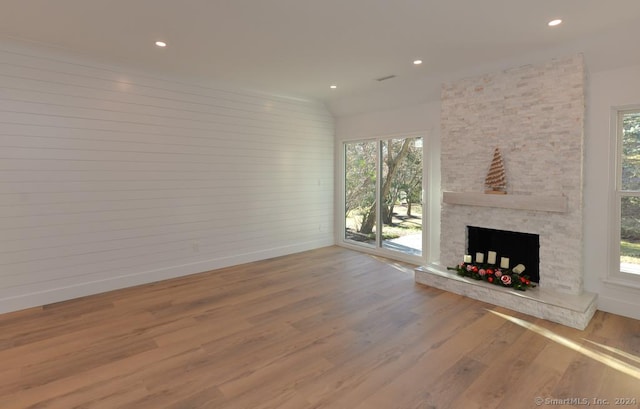 unfurnished living room with plenty of natural light and light hardwood / wood-style flooring