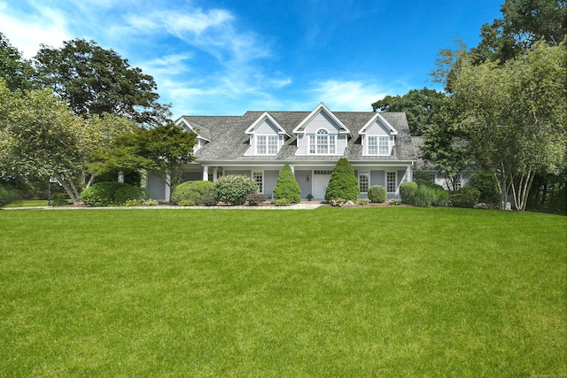 cape cod home with a front lawn