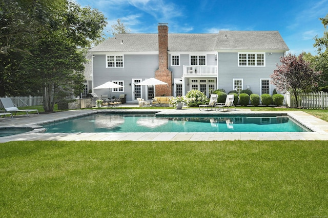 view of pool with a fenced in pool, a lawn, fence, and a patio