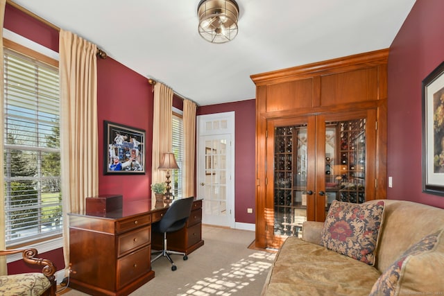 carpeted office space with french doors and baseboards