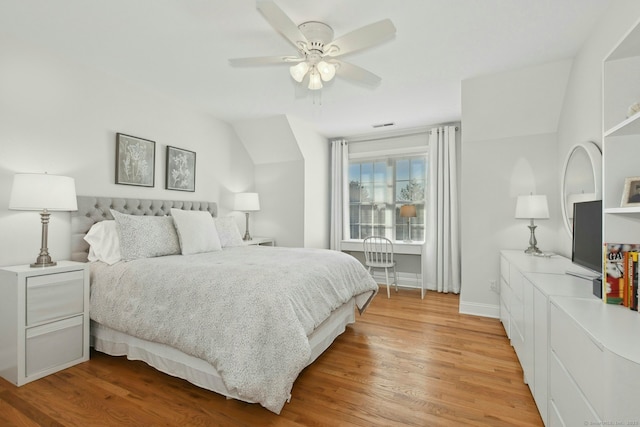 bedroom with ceiling fan, wood finished floors, and baseboards