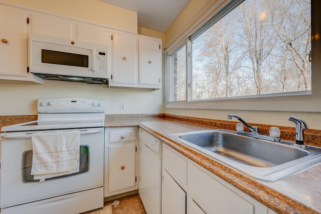 kitchen with white cabinets, white appliances, light tile patterned flooring, and sink