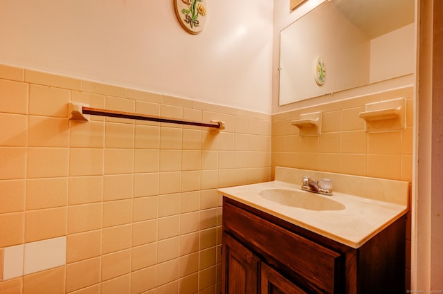 bathroom with vanity and tile walls