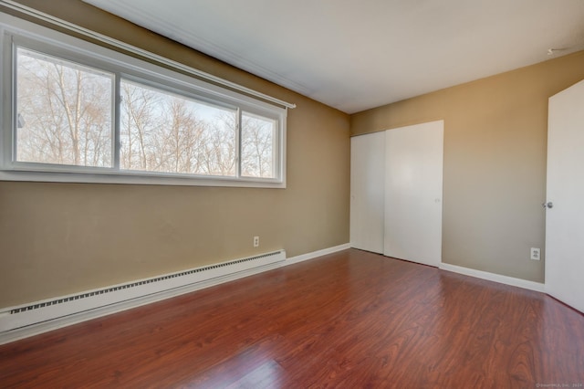 interior space featuring hardwood / wood-style flooring and a baseboard heating unit