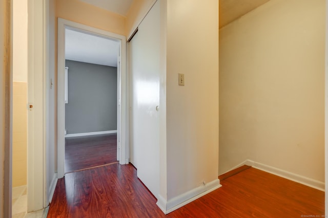 corridor with wood-type flooring