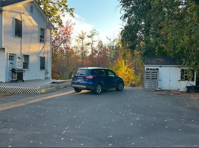 exterior space featuring a deck and a storage unit