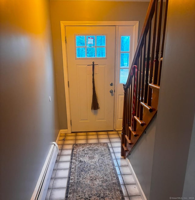 tiled foyer entrance with a baseboard radiator