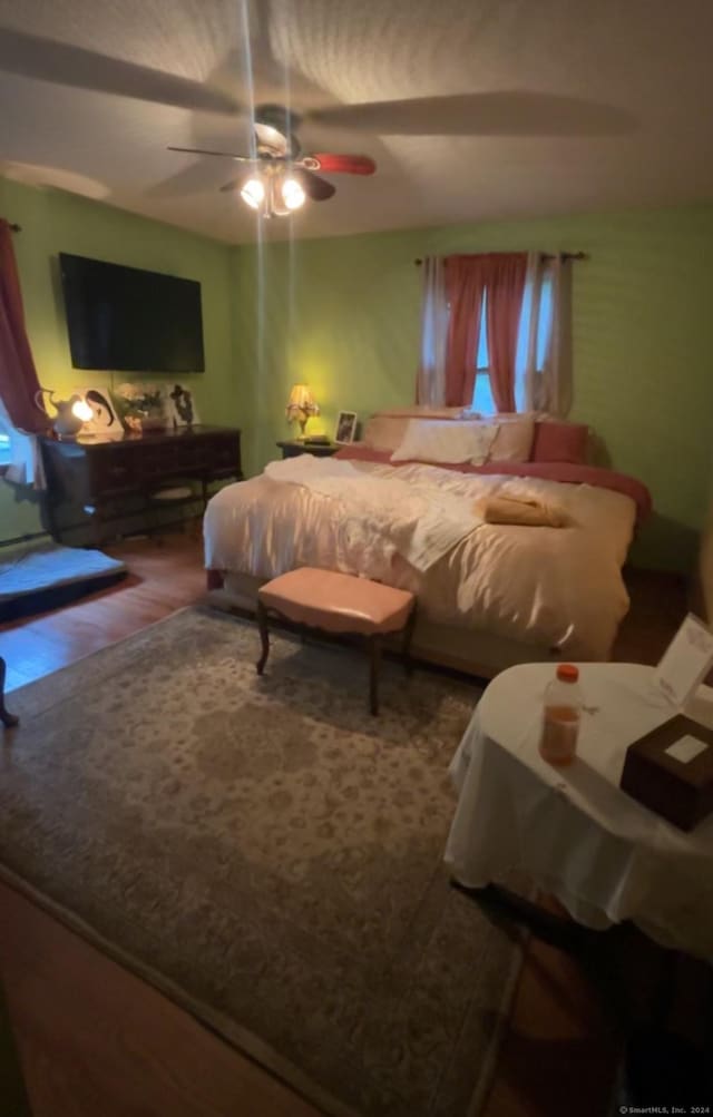 bedroom featuring hardwood / wood-style floors and ceiling fan