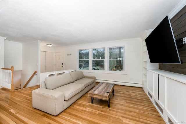 living room featuring light hardwood / wood-style floors, baseboard heating, and crown molding