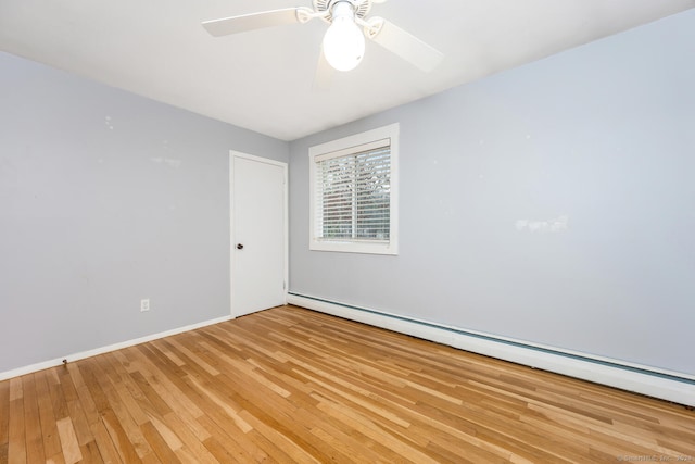 empty room with ceiling fan, baseboard heating, and light hardwood / wood-style flooring