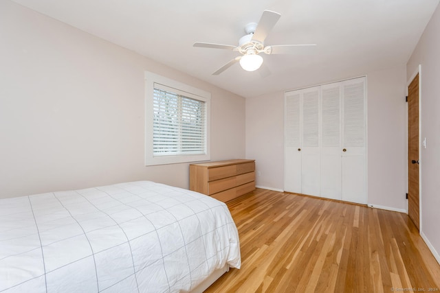 bedroom with a closet, ceiling fan, and light hardwood / wood-style flooring