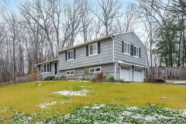 view of front of home with a garage and a front lawn