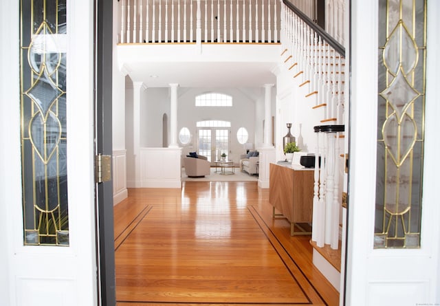 266 Great Plain Rd, Danbury, CT 06811 - foyer featuring light wood-style flooring, a wainscoted wall, a decorative wall, and decorative columns