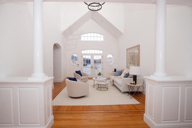 266 Great Plain Rd, Danbury, CT 06811 - living area with light wood-type flooring, ornate columns, a high ceiling, and arched walkways